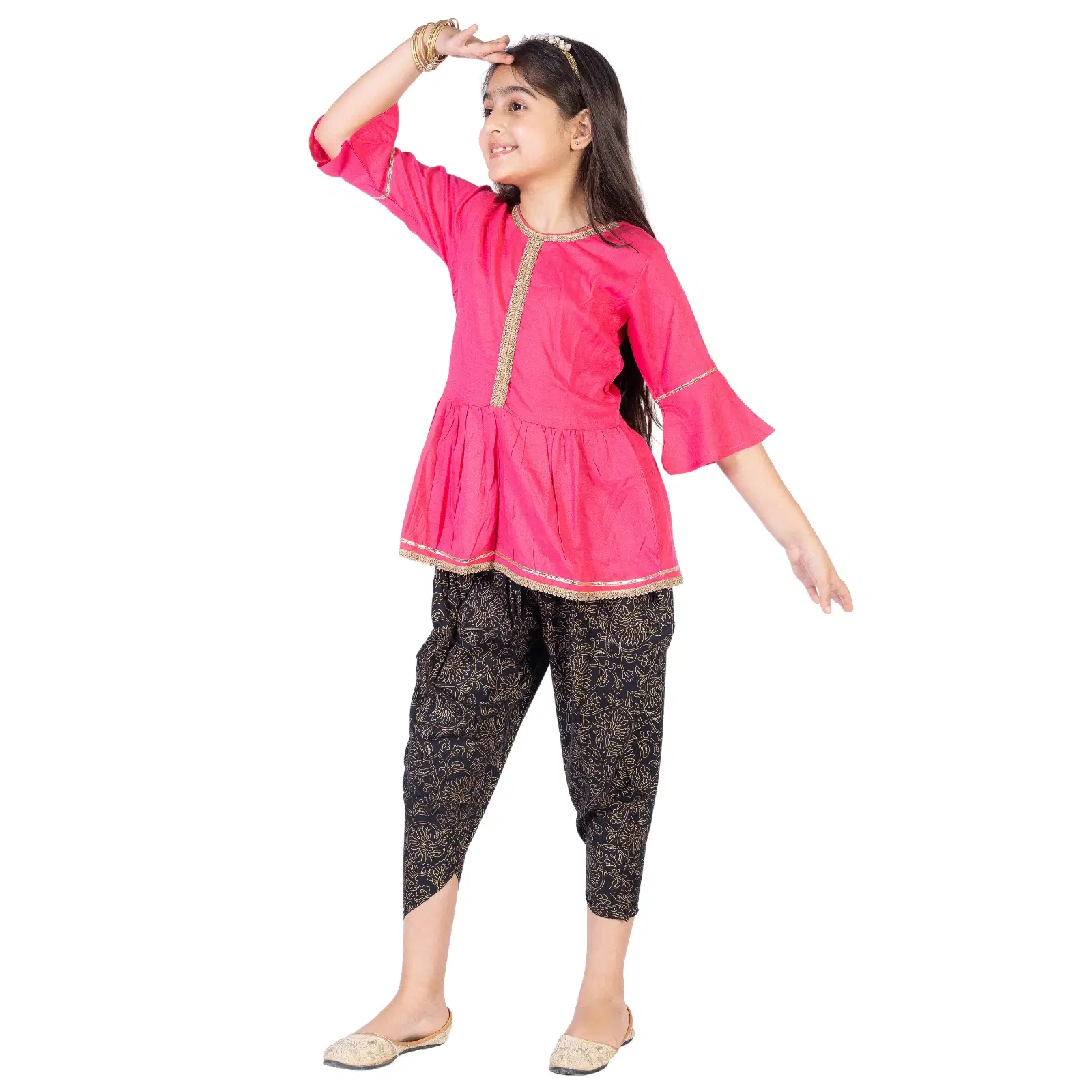 Girl wearing a bright pink peplum kurta with gold trim and black printed pants