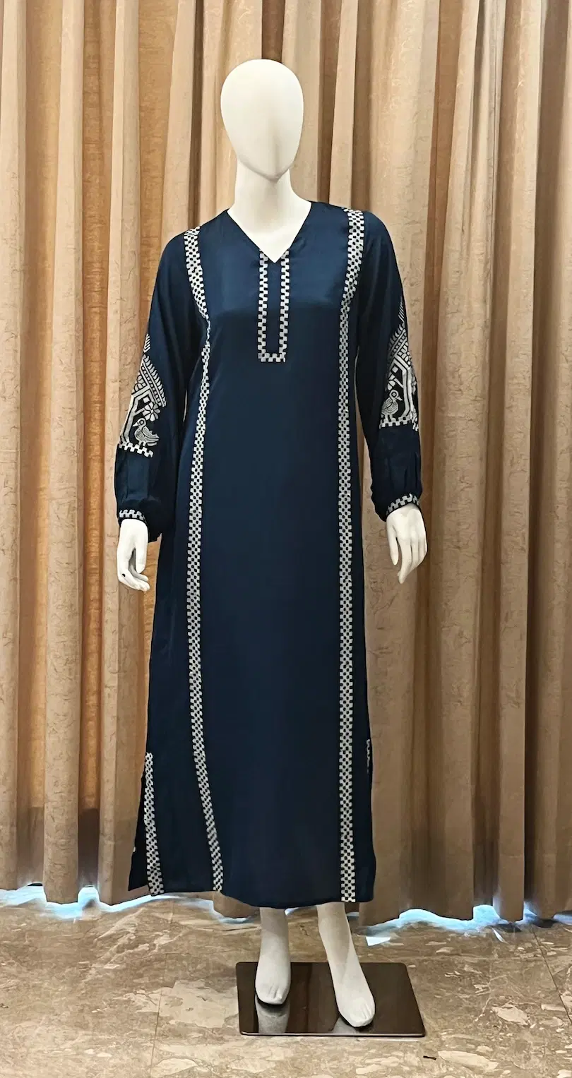 Navy blue long women's kurta dress with white embroidered trim on neckline, sleeves, and front panels
