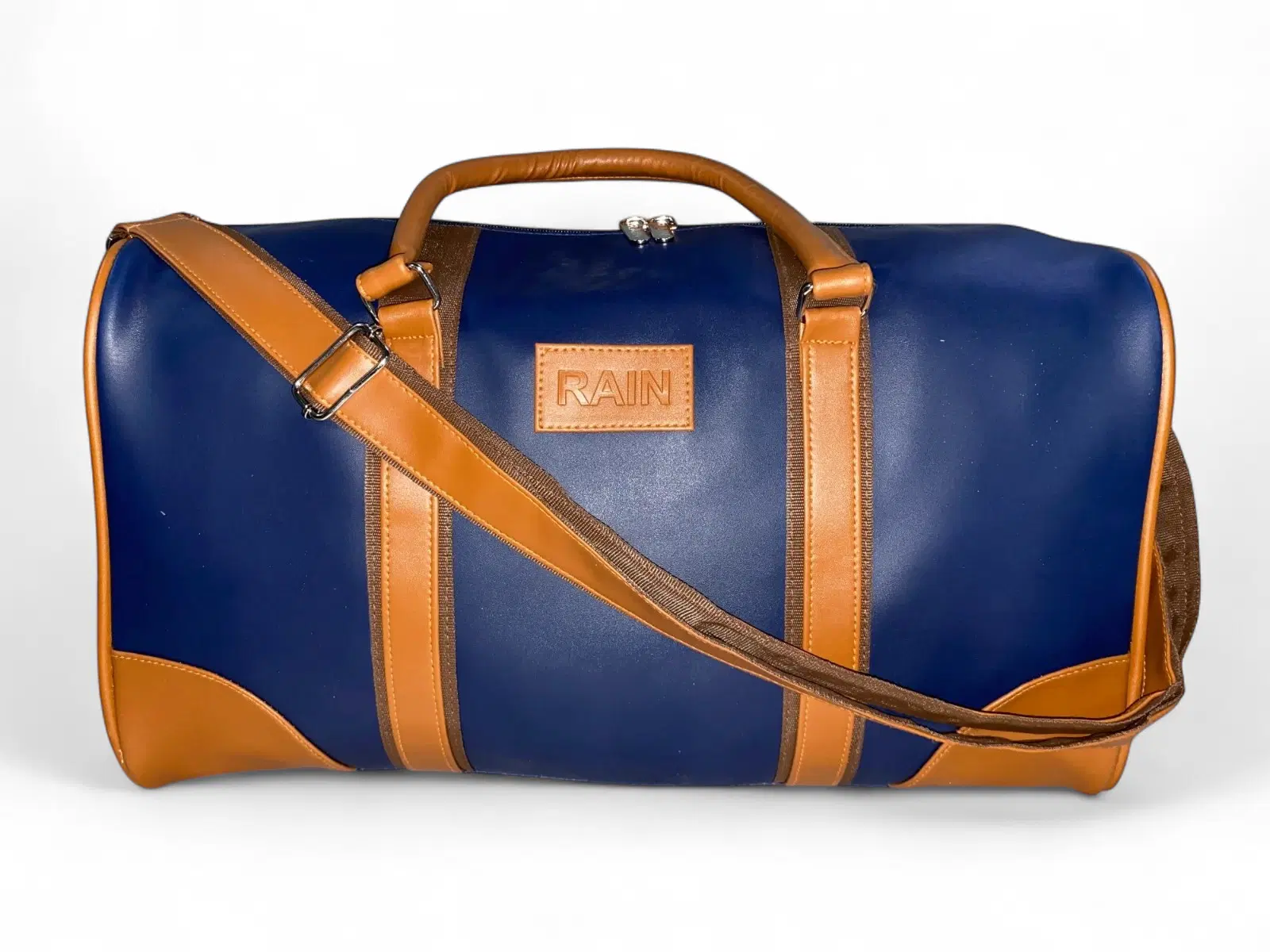 Rain Navy Blue Faux Leather Duffel Bag with Tan Handles