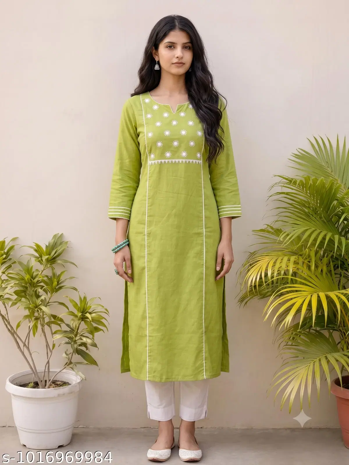 Woman wearing an olive green embroidered straight kurta with white pants and beige flats