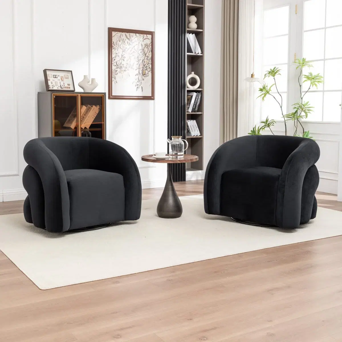 Front angled view of black upholstered barrel armchairs with rounded arms and swivel bases on a cream rug