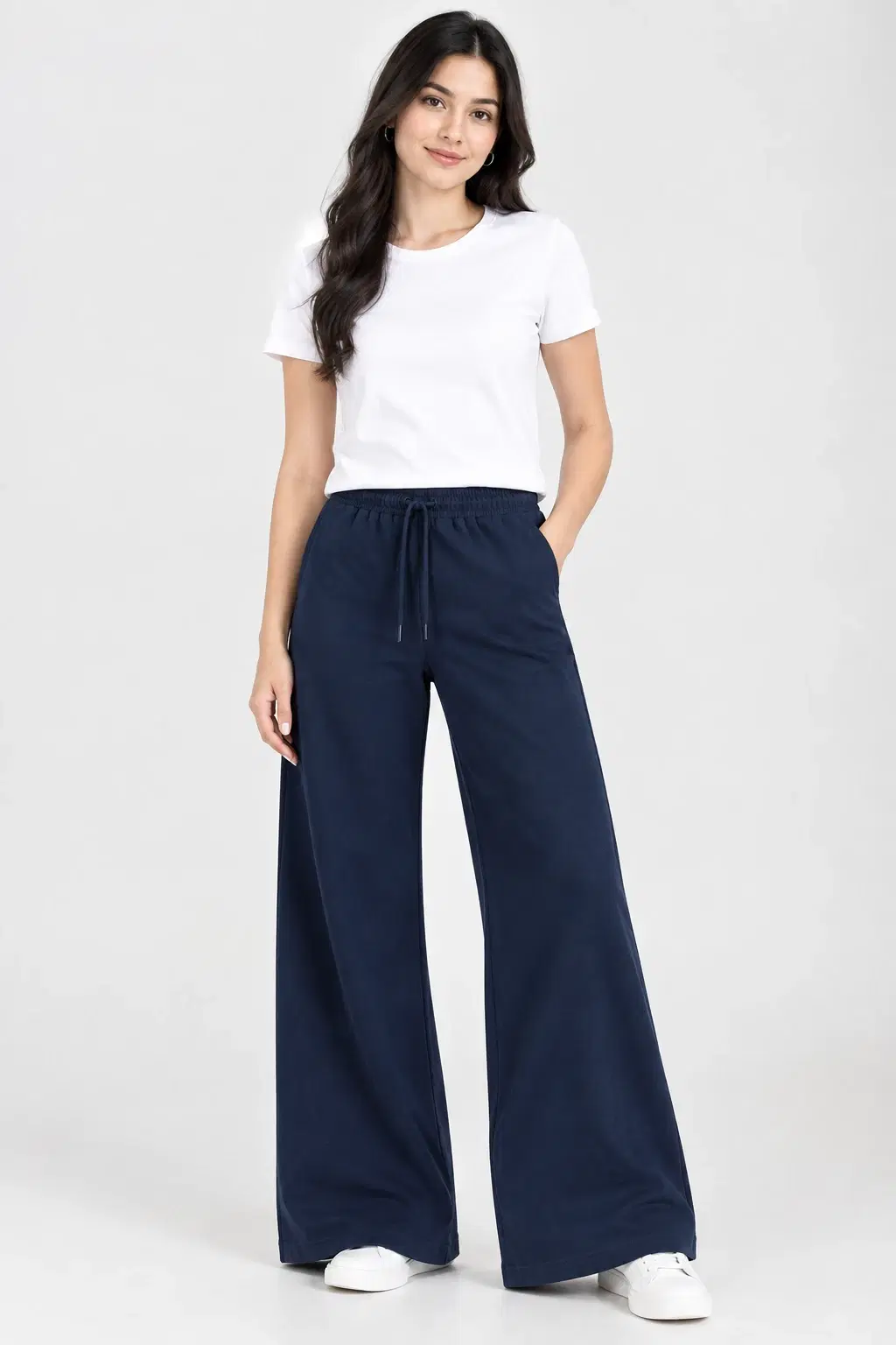 Front full-length view of navy wide-leg lounge pants with drawstring waist and side pockets, styled with a white tee