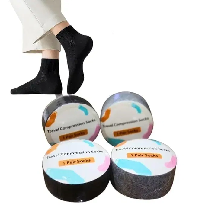 Black ankle compression socks shown worn on feet with four round travel sock containers below