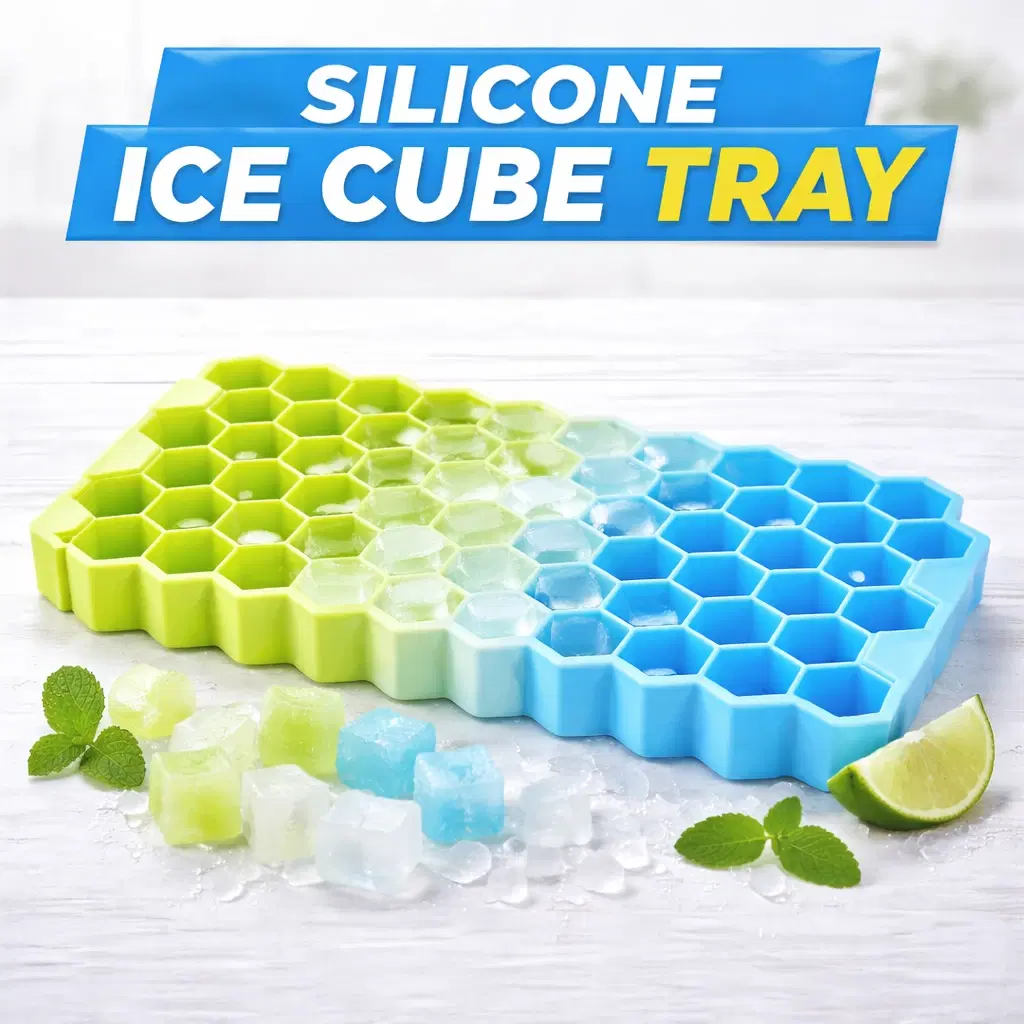 Blue and green hexagon silicone ice tray on a white surface with colored ice cubes, mint, and lime wedge