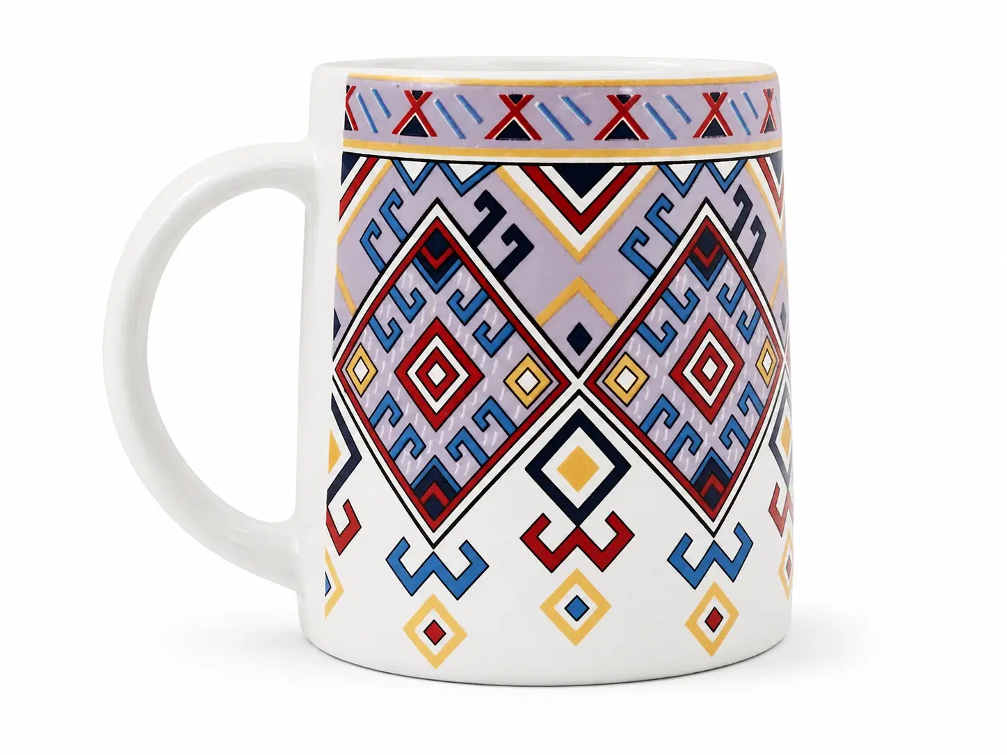White ceramic mug with colorful geometric tribal pattern and large handle, shown from the side