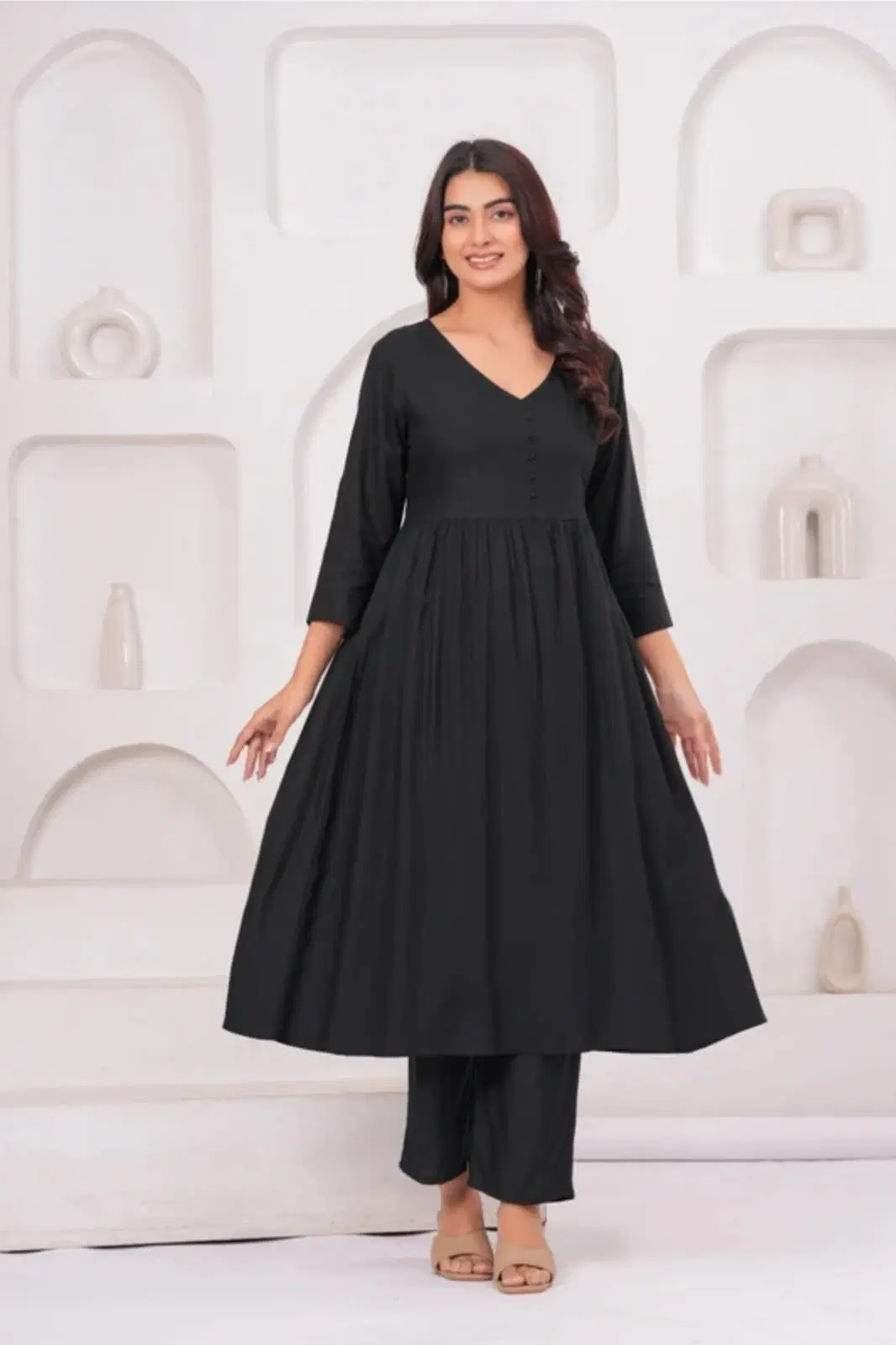 Front view of a black Anarkali kurta set with V-neck, 3/4 sleeves and matching pants on a model