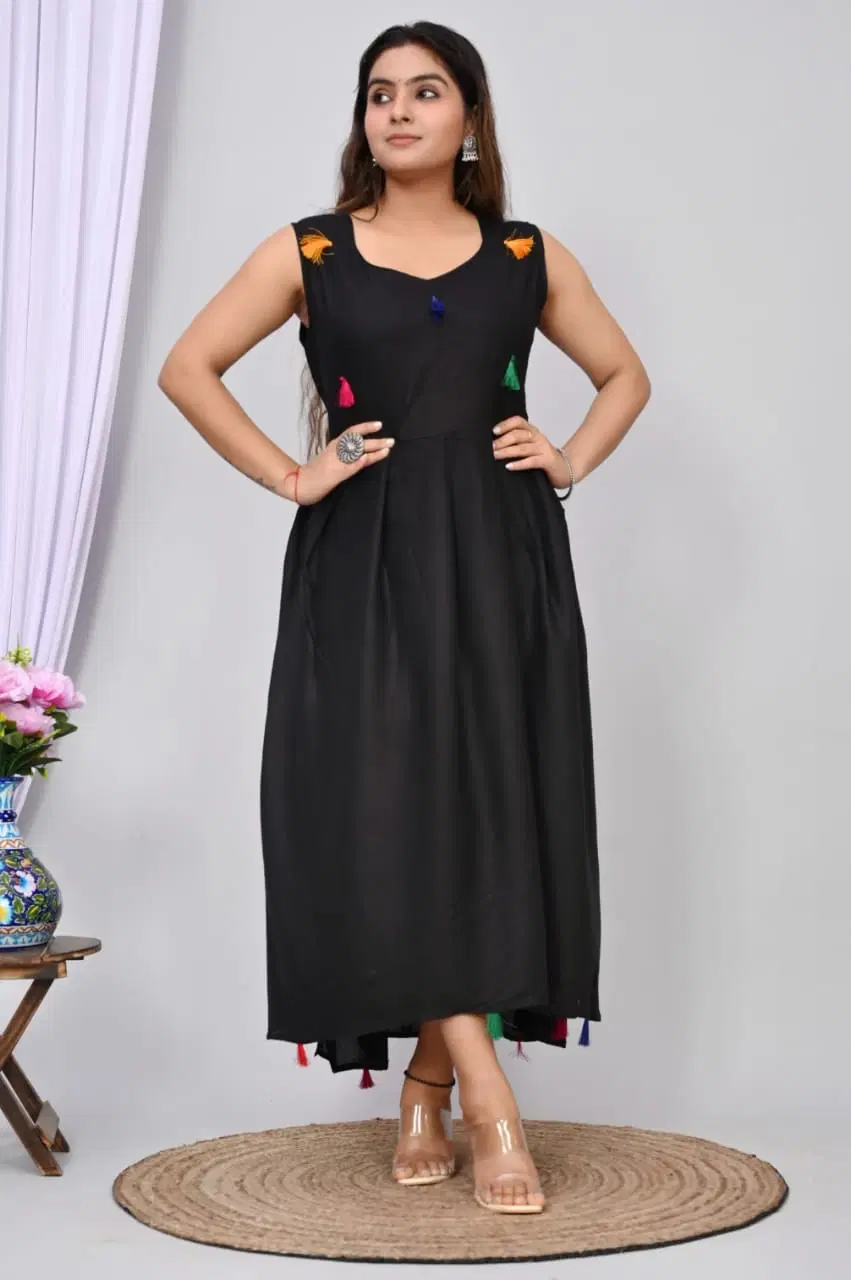 Front view of black sleeveless maxi dress with multicolor tassels and flowy A-line silhouette