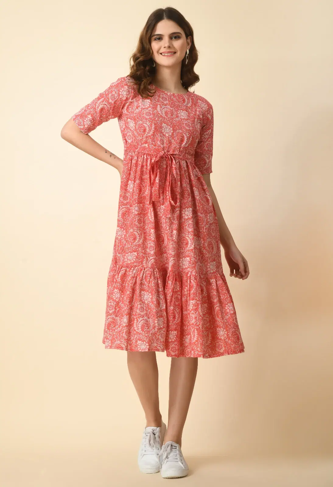 Front full-length view of coral printed midi dress with round neck, elbow sleeves and tie-up waist