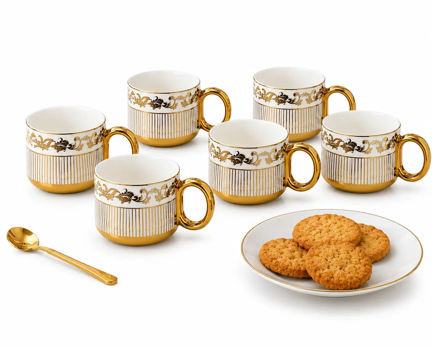 Six white ceramic tea cups with gold handles and floral detailing beside a plate of biscuits and gold spoon