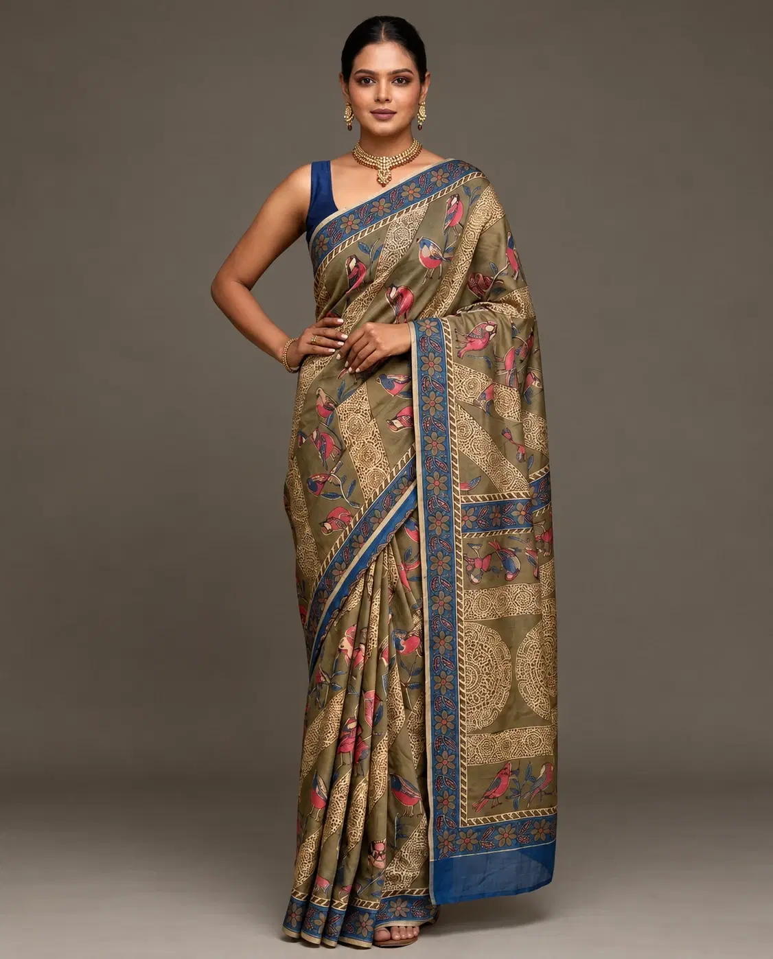 Front full-length view of olive saree with pink bird motifs and wide blue floral border on a model