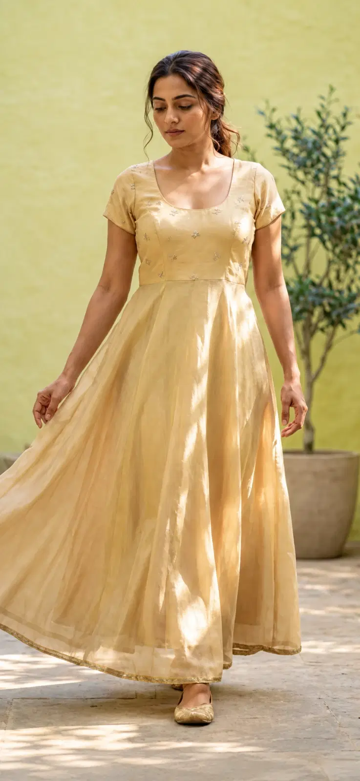 Front view of a beige flared maxi dress with short sleeves, scoop neckline and subtle bodice embroidery