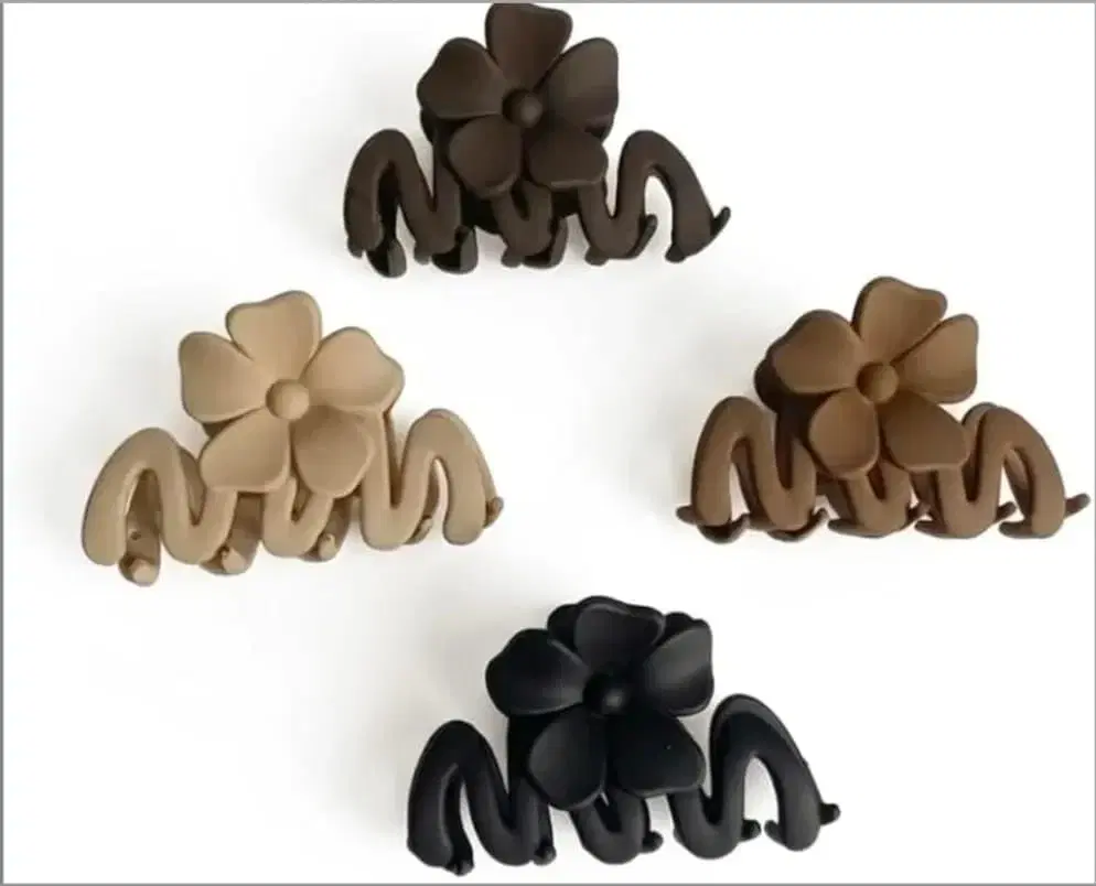 Pack of four extra large matte hair claw clips in multicolor neutral shades.