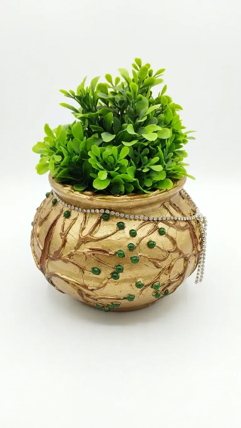 Green artificial plant in an ornate gold decorative pot with bead detailing